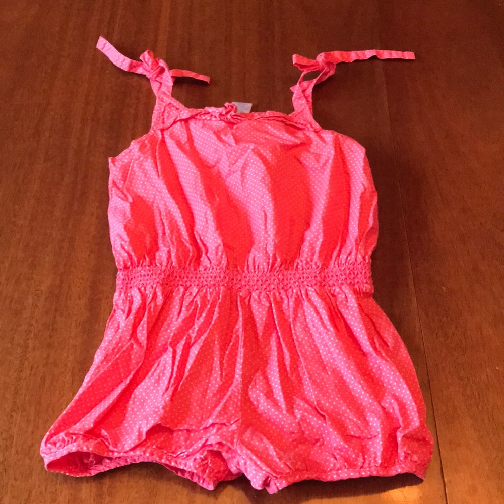 Child’s pink with white polka dots romper
